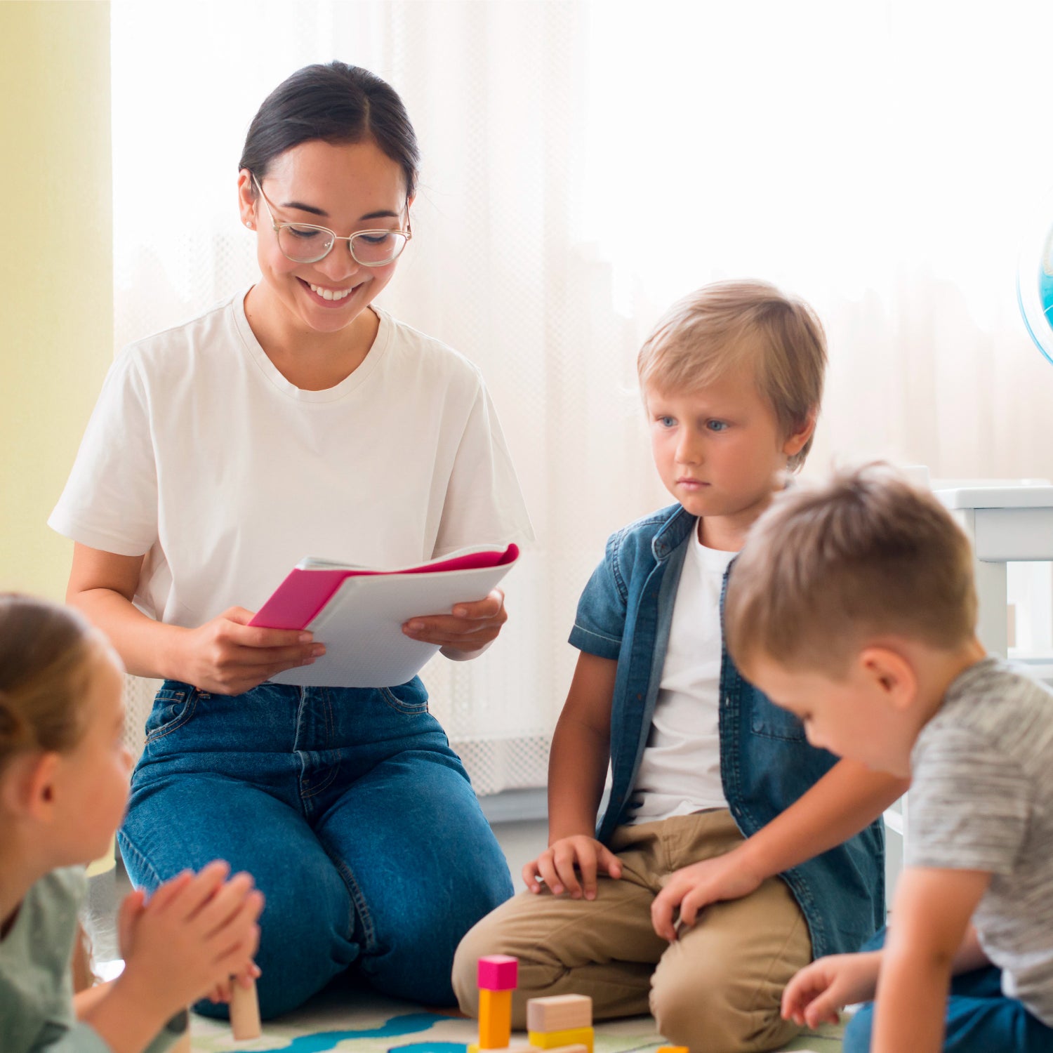 an educational or childcare setting where a female teacher or caregiver is engaging with young children, possibly during a lesson or activity.